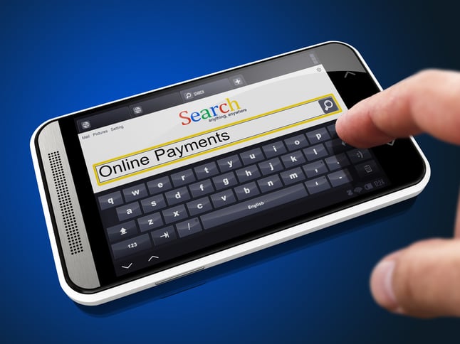Online Payments in Search String - Finger Presses the Button on Modern Smartphone on Blue Background.